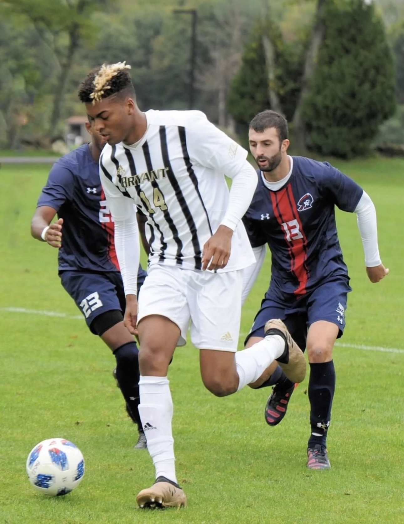 Tony breaking away from two defenders with the ball