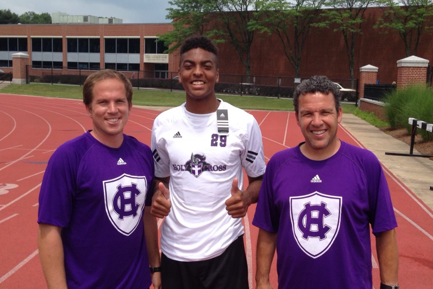 The Pathwai founder between the two Holy Cross coaches he later signed with, at a showcase